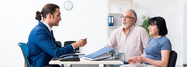 Financial advisor talking to man and a woman at a desk