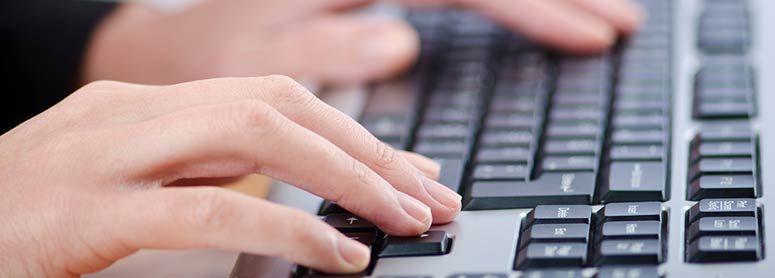 Hands typing on a keyboard