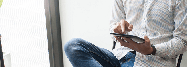 Person sitting with tablet