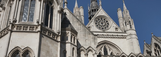 The Royal Courts of Justice in London against a blue sky