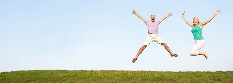 Two people jumping happily in the air